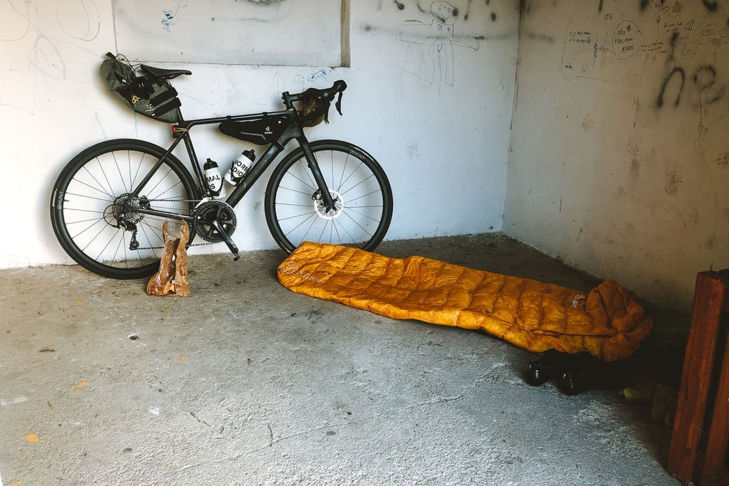 Gustav's bike and sleeping bag in a empty room