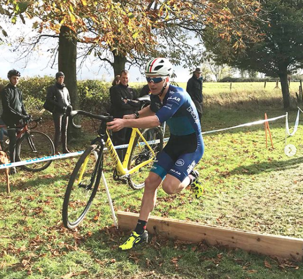 Hank jumping over an obstacle in a CX race