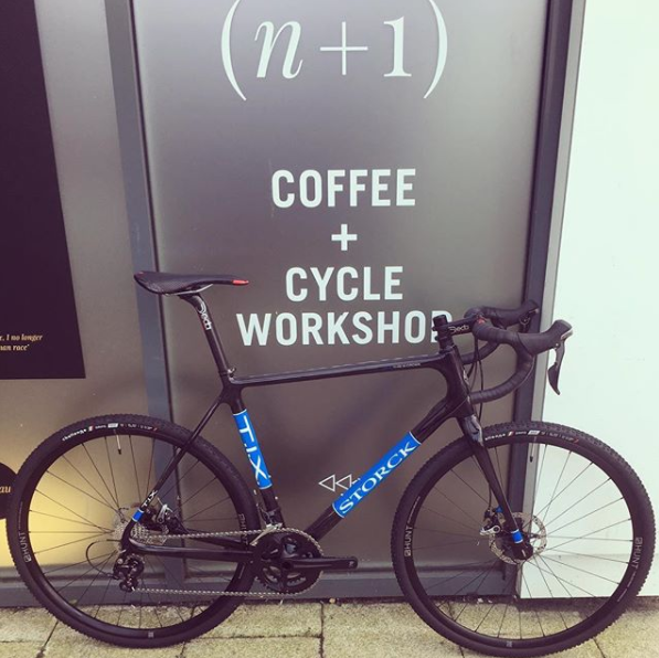 Dan Pullen's Stock T.I.X in front of a 'Coffee+Cycle Workshop' sign