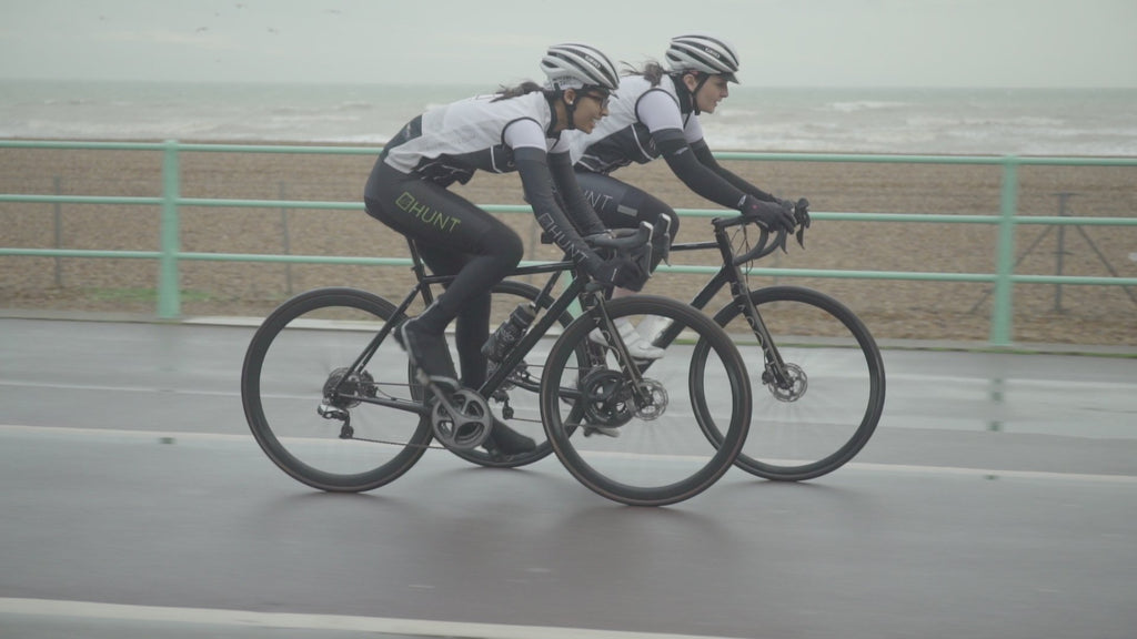 Two cyclists riding down Brighton seafront with 4 Seasons wheels