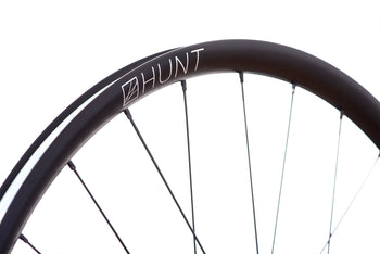 <h1>Rims</h1><i>A strong and lightweight 6066-T6 heat-treated rim features an asymmetric shape which is inverted from front to rear to provide balanced higher spoke tensions meaning your spokes stay tight for the long term. The rim profile is disc specific which allows higher-strength to weight as no reinforcement is required for a braking surface. The extra wide rim at 29mm (25mm internal) which creates a great tyre profile with wider 28-54mm tyres, giving excellent grip and lower rolling resistance.</i>