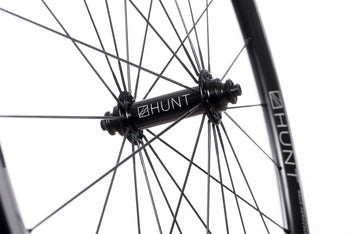<h1>Hubs</h1><i>The hubs on the Race Aero SuperDura benefit from larger 12mm front and 15mm rear axles. This combined with them being machined from hard and strong 7075-T6 heat treated alloy means that they easily withstand the higher loads created by larger riders. Plus the cold forged then CNC machined hub shell means the metal grain structure is ideally aligned to handle the high spoke loads, the work hardening from the cold forging also adds extra strength.</i>